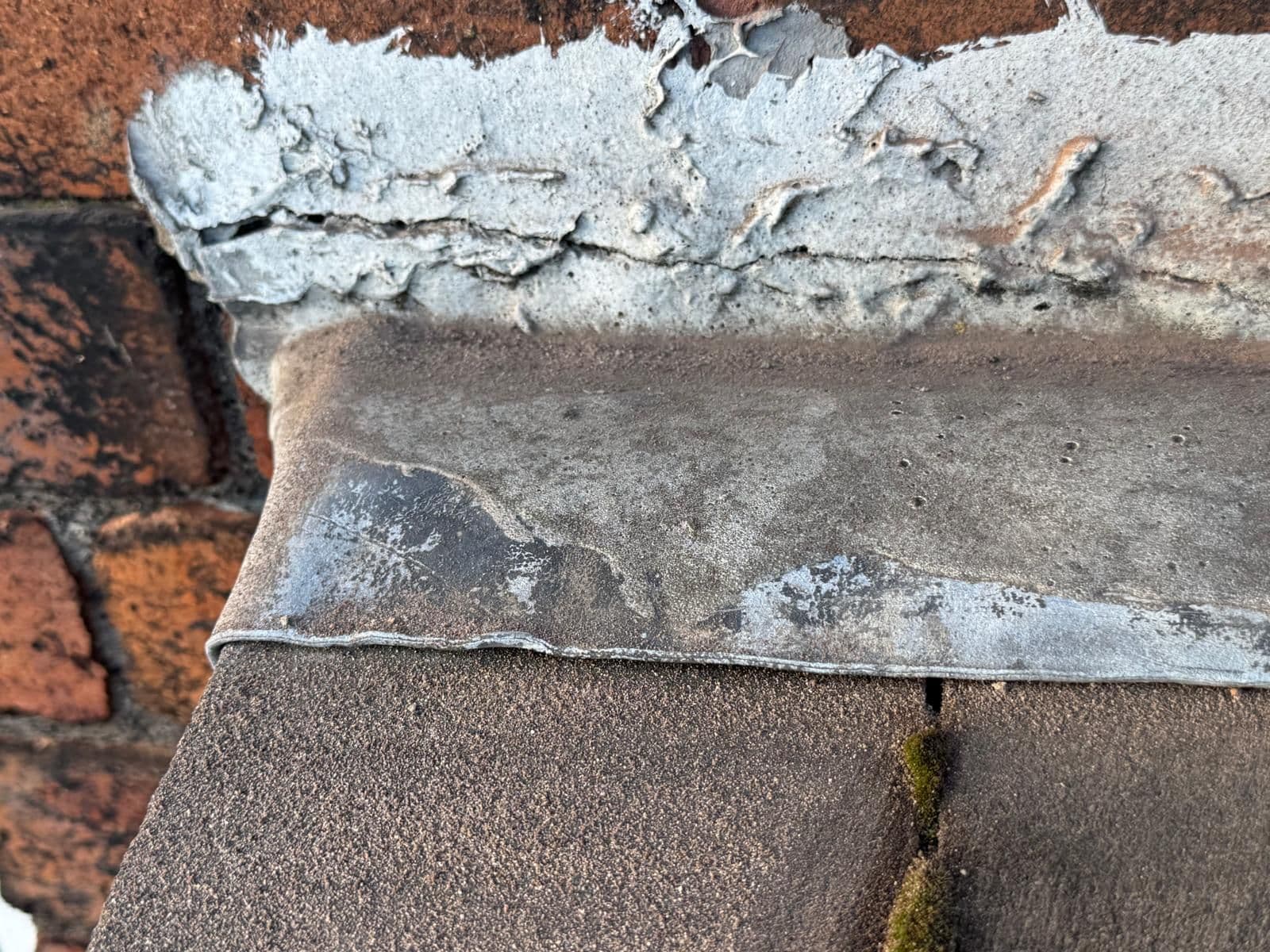Close-up: Damaged flashing vs. fresh lead — before